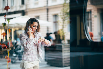 Young businesswoman talking on the phone on street